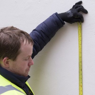 measuring ready for a green wall panel