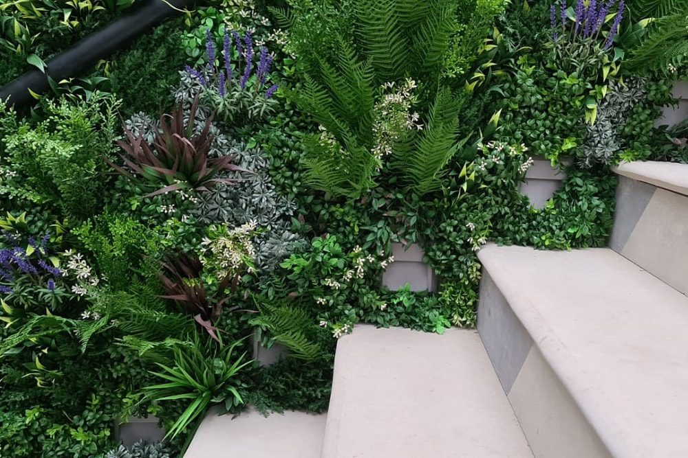 artificial green wall by handrail in czech republic garden