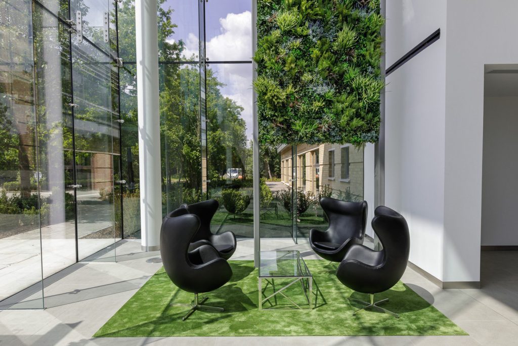 modern glass office area and artificial green walls