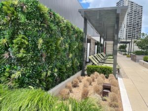 a poolside artificial green wall installation