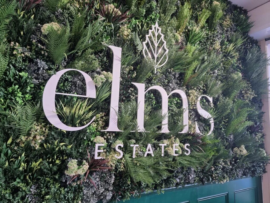 Close up of an artificial green wall with a logo in an estate agent in London
