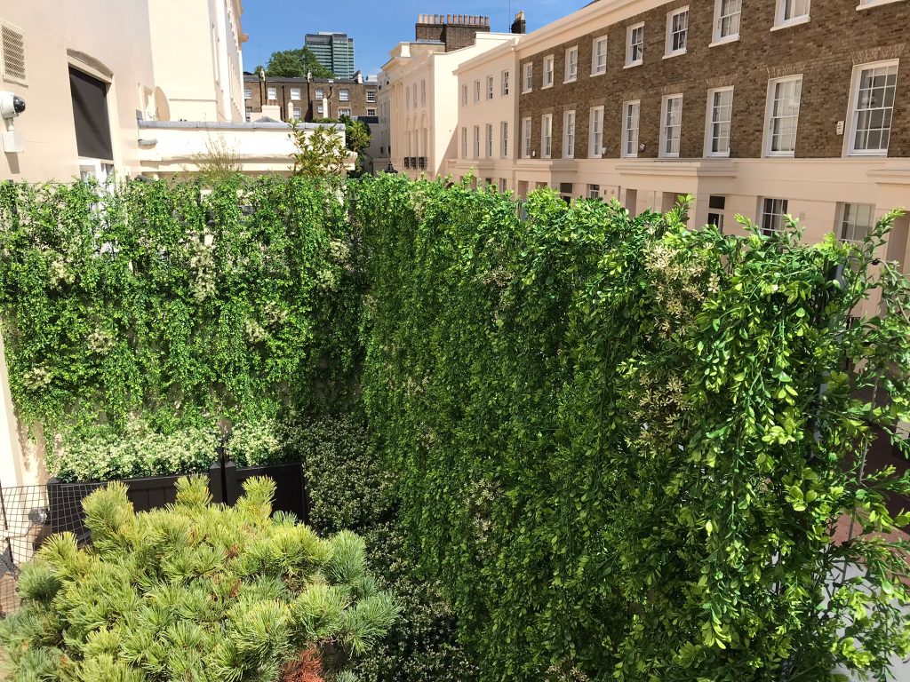 a fake ivy wall in a London garden