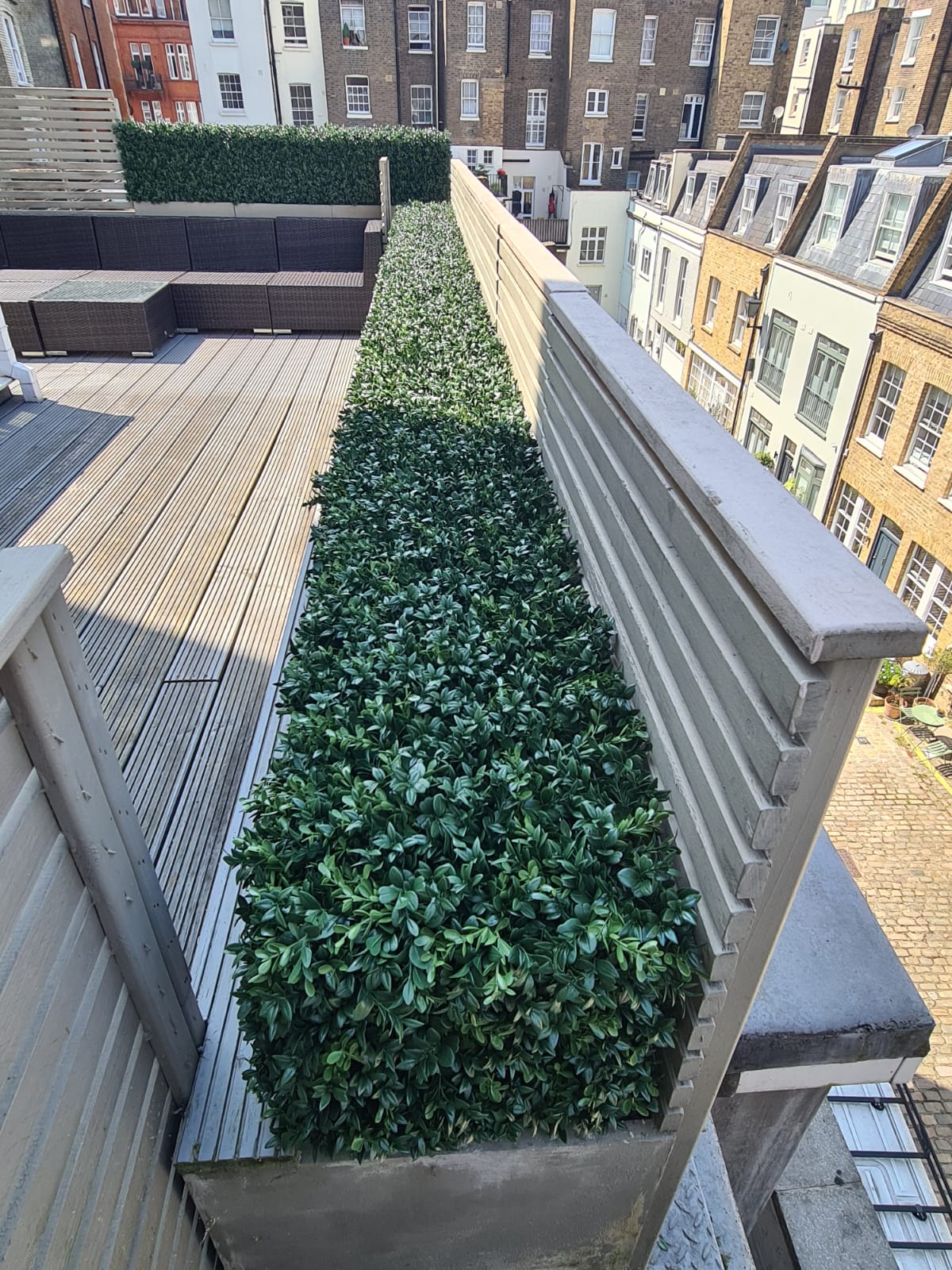 A faux boxwood hedge installed on a roof terrace